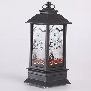 Close-up of Halloween lantern with spooky ghost and pumpkin prints on frosted glass