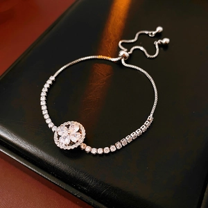 Macro view of silver clover bracelet with zircon stones and adjustable drawstring slider