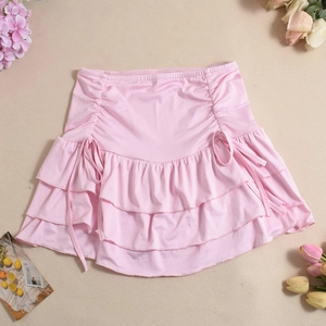 Detail of pink tiered ruffle mini skirt with elastic waist and side drawstring feature