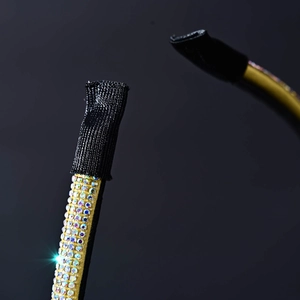 Detailed macro view of thin golden headband featuring sparkling colorful rhinestones
