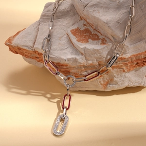 Detail of silver long Y-shaped chain necklace with rhinestones and red enamel coating
