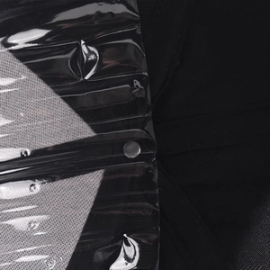 Detailed view of the black twill fabric and metal rivet under protective film