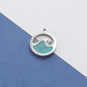 Detail of round silver ocean wave pendant with turquoise inlay on a two-tone background