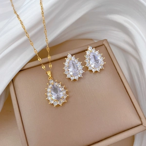 Titanium steel waterdrop necklace and earrings set with crystal stones on silk background