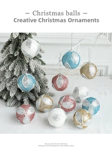 Close-up of elegant 8cm foam Christmas balls with glittery leaves and hanging strings