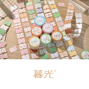 Close-up of floral washi tape set with plaid and fruit patterns on wood surface
