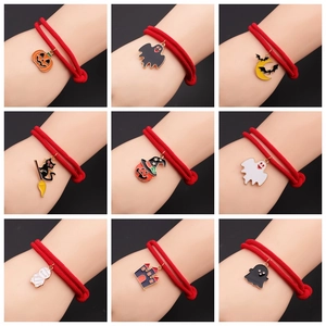 Detail of nine Halloween alloy enamel charms on adjustable red cord bracelets
