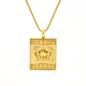 Detail of gold square crown pendant with embossed celestial patterns on a box chain