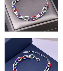 Detail of chunky stainless steel chain bracelet with colorful enamel links and lobster clasp