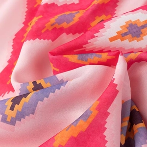 Close-up of pink ethnic geometric print fabric texture and high-quality weave pattern