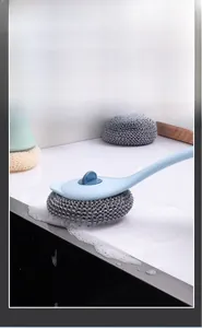 Detail showing the long handle kitchen cleaning brush generating rich foam with wire ball