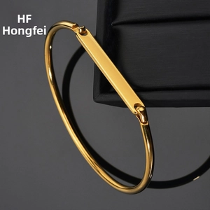 Macro shot of minimalist gold plated stainless steel bracelet with a smooth rectangle bar