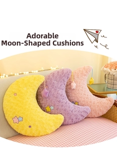 Detail of plush moon-shaped pillows in yellow, pink and purple with star embroidery