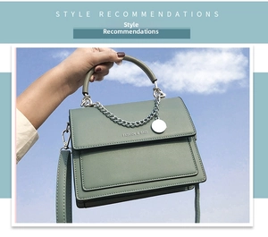 Detail of green PU leather crossbody bag with silver chain and FASHION logo engraving