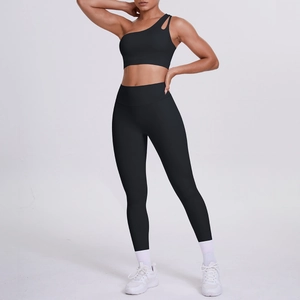 Detail of black one-shoulder sports bra and high-waist compression leggings set