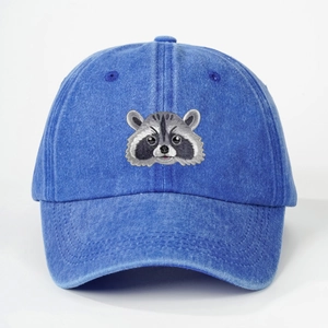 Vintage mid-blue washed cotton baseball cap featuring detailed raccoon head embroidery