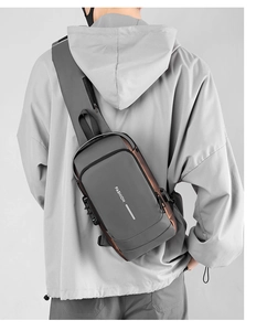 Detail view of anti-theft combination lock and waterproof fabric on men chest bag