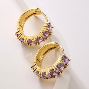Elegant gold earrings with lavender cubic zirconia in a minimalist huggie hoop design