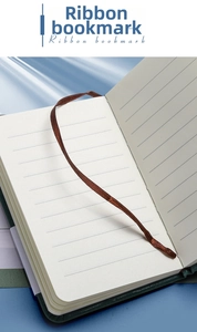 Detail view of the premium dark green notebook featuring a ribbon bookmark and lined paper