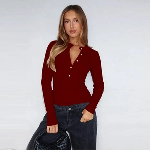 Detail shot of deep red ribbed knit long sleeve cardigan with elegant white button closure