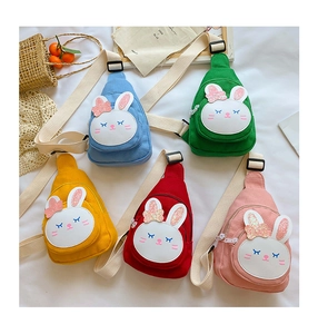 Flat lay display of colorful bunny canvas chest bags in five bright cartoon designs