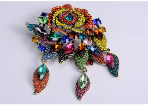 Detailed macro view of vintage baroque brooch with multi-color rhinestones and pendants