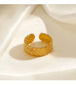 Detailed close-up of golden wheat grain pattern relief on an adjustable open ring