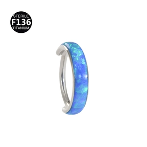 Macro detail of sterile F136 titanium segment ring set with vibrant blue opal stone
