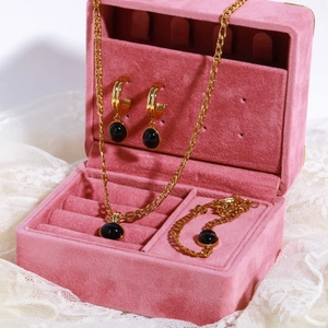 Exquisite gold jewelry set with black round gemstones in a pink velvet gift box