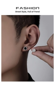 Close-up of mens round pave crystal earrings in black and silver finish on model