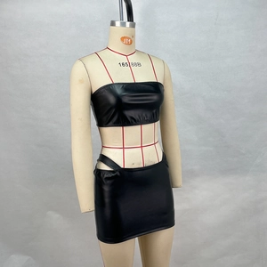 Detail of sleek black PU leather two-piece set featuring a tube top and bodycon mini skirt