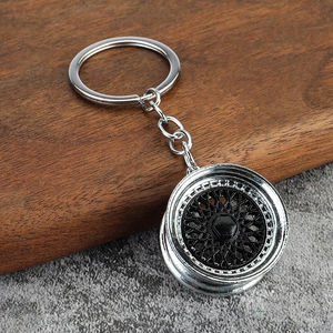 Macro detail of a 3D BBS style miniature car wheel rim keychain with polished metal finish