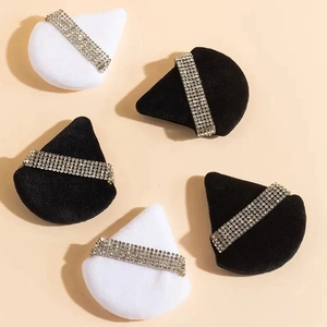 Triangular makeup puffs in black and white with sparkling rhinestone crystal strap detail