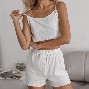 Three-piece white loungewear set with knitted heart patterns and ribbed button details