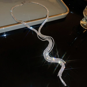 Detailed view of layered silver-toned tassel necklace with sparkling rhinestones and crystals