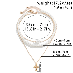 Three-layer gold beaded necklace with pearl accents and a cross pendant detail view