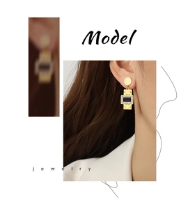 Detail of gold geometric earrings with black rectangular inlay and white zircons on model