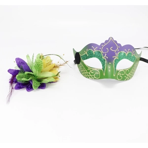 Detail of purple and green masquerade mask set with feathers and floral accent