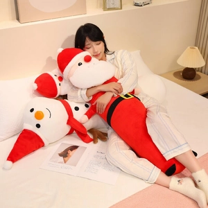 Detail view of plush long Christmas pillow in Santa Claus and snowman cartoon design