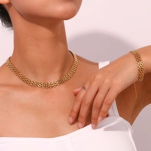 Detailed view of gold-plated woven watch-band style chain necklace and bracelet set
