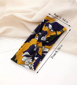 Detailed view of floral twist headband showing 9cm width and 21cm length dimensions