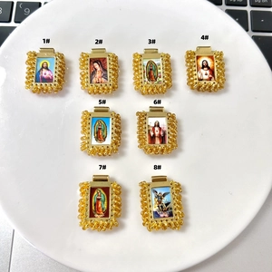 Macro shot of 8 religious portrait pendants with gold trim for DIY jewelry making