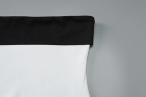 Detailed macro shot of contrast stitching and elastic waistband on slim fit dress
