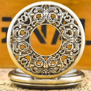 Close-up of vintage bronze pocket watch featuring intricate hollow flower carving detail