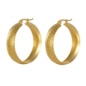 Close-up of gold plated large hoop earrings with textured honeycomb embossed patterns
