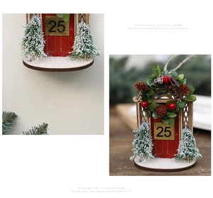 Detail of wooden Christmas house ornament featuring number 25, mini trees and snowy texture