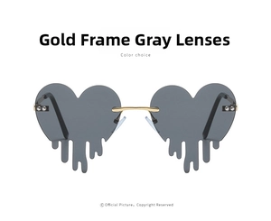 Detail of heart-shaped sunglasses with gold metal frame and unique grey tear drip lenses