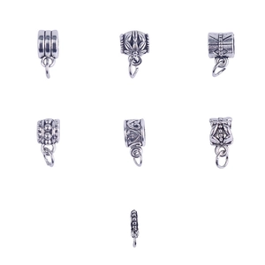 Detailed view of seven silver DIY charms including heart and flower patterns for bracelets