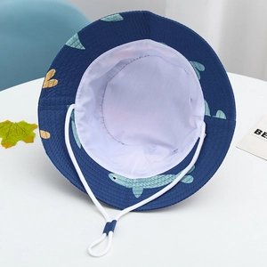 Detail of kids sun hat with colorful fish pattern, white lining and adjustable chin strap