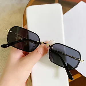 Vintage rectangle metal sunglasses with gold spiral temples and grey lenses